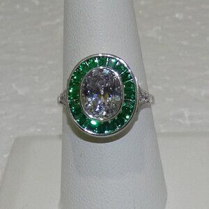 EMERALD BAGUETTE HALO AROUND LIGHT EMERALD CENTER STONE RING